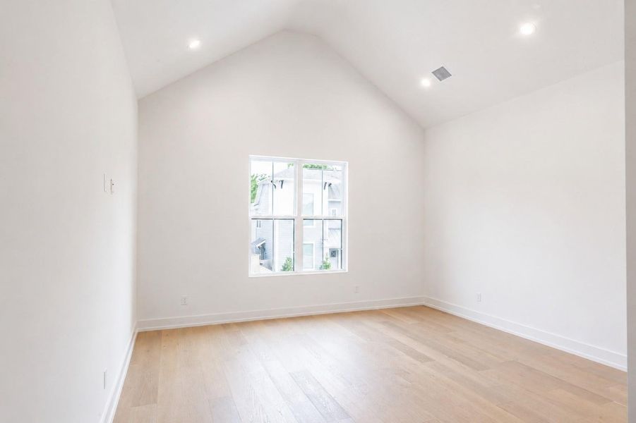 Primary bedroom has vaulted ceilings and plenty of natural light Primary bedroom has vaulted ceilings and plenty of natural light