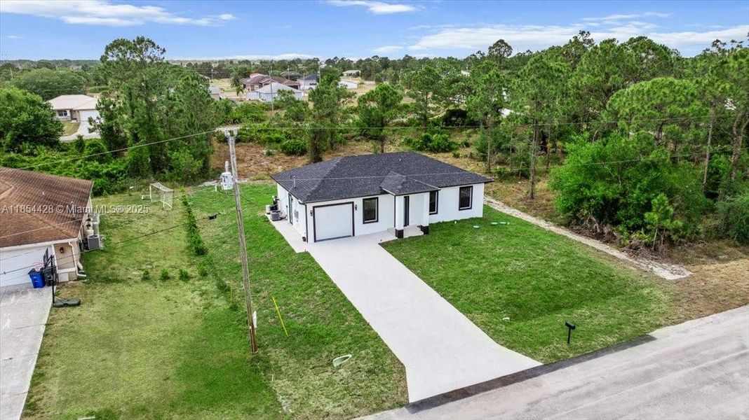 Front exterior of a new home in , Lehigh Acres, FL, highlighting curb appeal (Image 16). Front exterior of a new home in , Lehigh Acres, FL, highlighting curb appeal (Image 16).