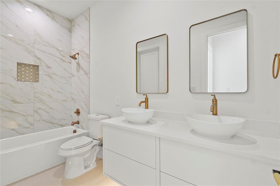 Bathroom featuring tub / shower combination and double vanity Bathroom featuring tub / shower combination and double vanity