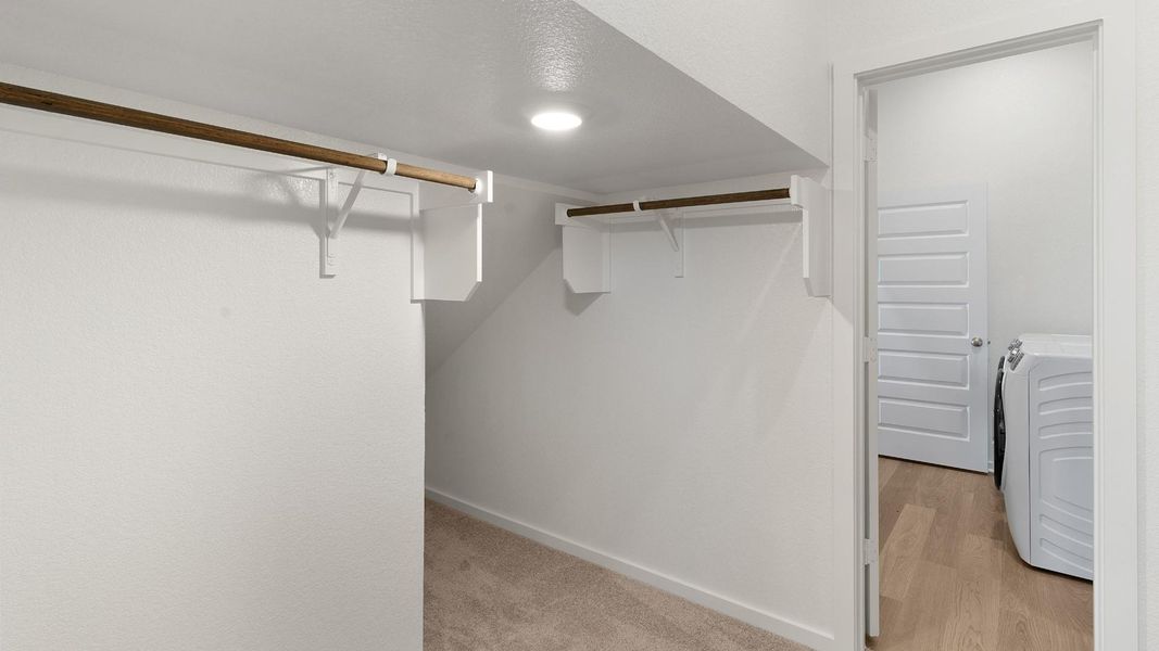Functional closet space provides ample storage, complemented by a convenient laundry area nearby. Functional closet space provides ample storage, complemented by a convenient laundry area nearby.