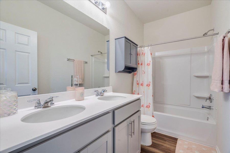 Guest bathroom features double vanity and tub/shower combo Guest bathroom features double vanity and tub/shower combo