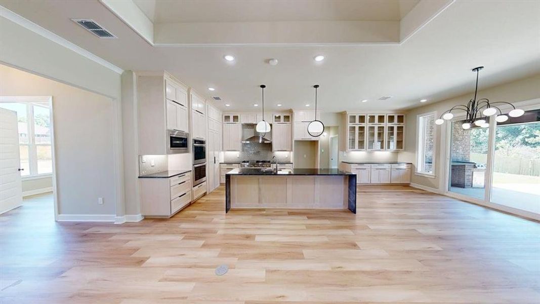 Kitchen featuring dark countertops, recessed lighting, appliances with stainless steel finishes, baseboards, and tasteful backsplash