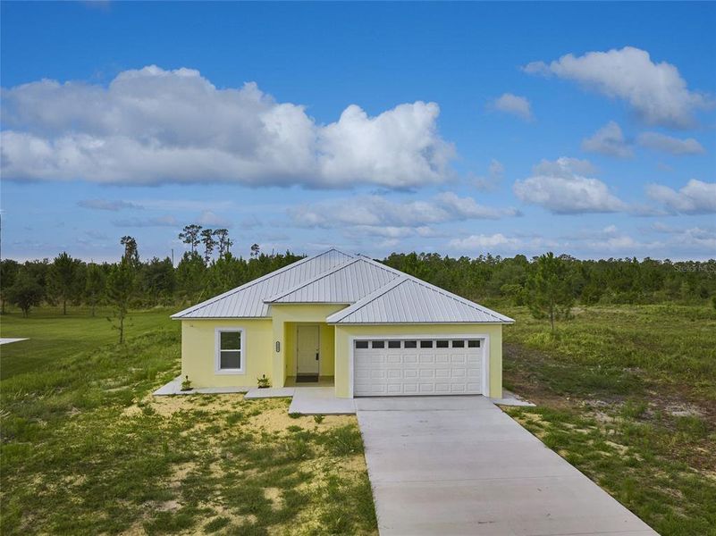 Front exterior of a new home in , Indian Lake Estates, FL, highlighting curb appeal (Image 1). Front exterior of a new home in , Indian Lake Estates, FL, highlighting curb appeal (Image 1).