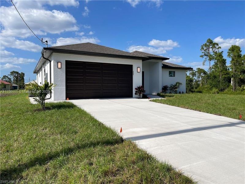 Front exterior of a new home in , Lehigh Acres, FL, highlighting curb appeal (Image 2).