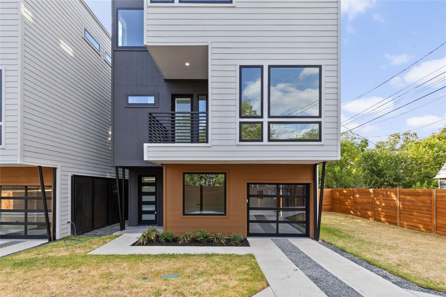Bold geometric lines and warm wood accents define this striking multi-level contemporary exterior design.