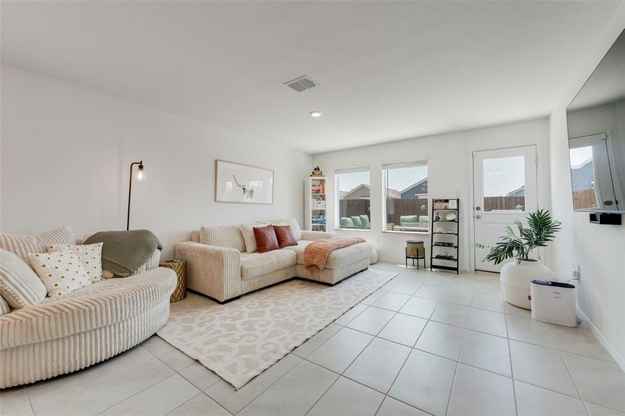 Living area featuring light tile patterned floors and recessed lighting Living area featuring light tile patterned floors and recessed lighting