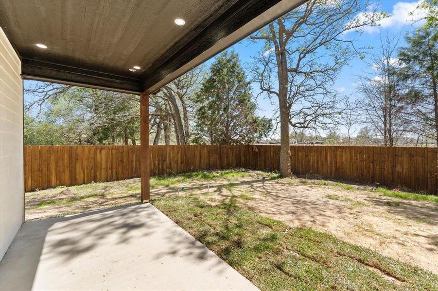 Privacy Fenced backyard featuring a covered patio area with direct access to living for entertaining