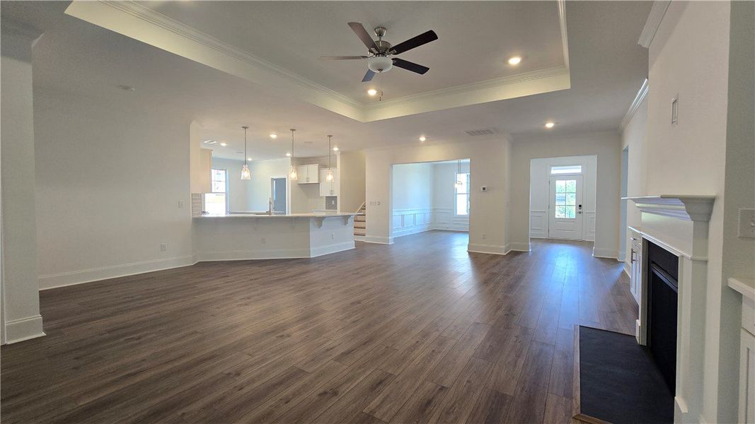 An open concept living area features sleek vinyl f