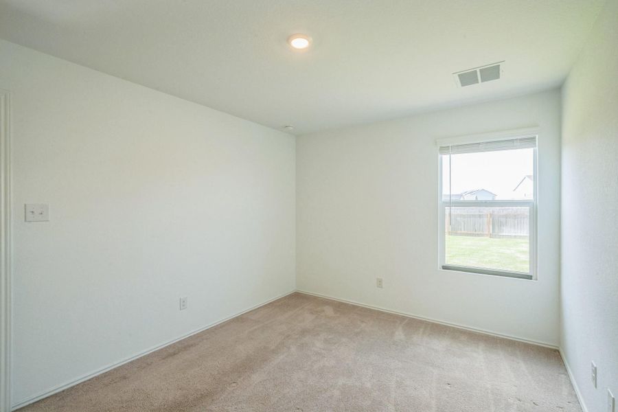 A well-lit, neutral-toned room offers a peaceful retreat with views of the private yard. A well-lit, neutral-toned room offers a peaceful retreat with views of the private yard.