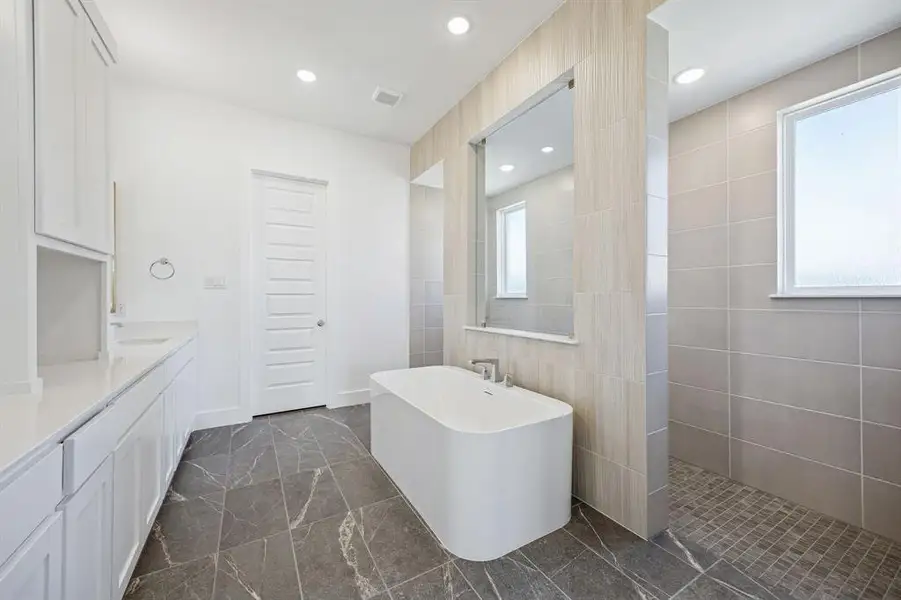 Our Justin plan features our signature bath with walk through shower and free standing tub!