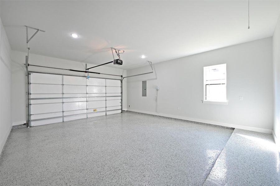 The two-car garage featuring durable epoxy flooring for a clean, polished, and easy-to-maintain finish. The two-car garage featuring durable epoxy flooring for a clean, polished, and easy-to-maintain finish.
