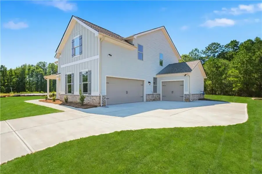 Front exterior of a new home in Brighton, Locust Grove, GA, highlighting curb appeal (Image 19).