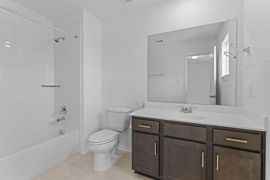 The secondary bath features tile flooring, white cabinetry and light countertops and a shower/tub combo. Perfect for accommodating any visiting family and friends. The secondary bath features tile flooring, white cabinetry and light countertops and a shower/tub combo. Perfect for accommodating any visiting family and friends.