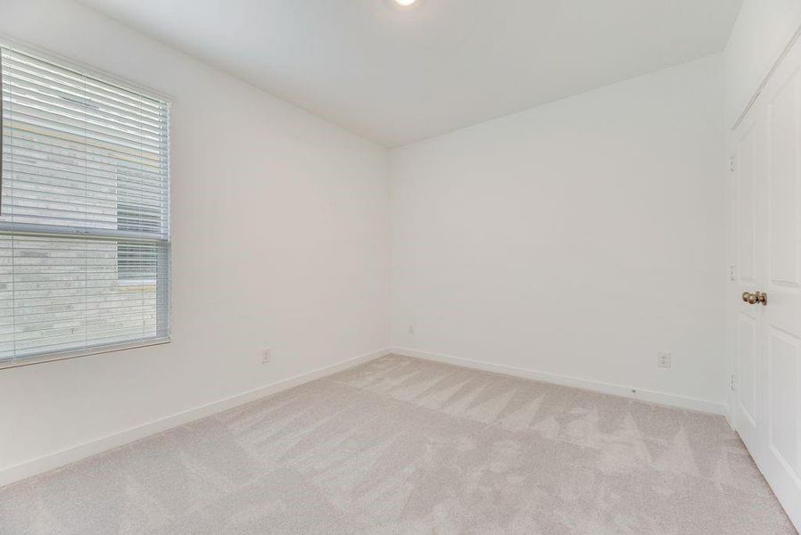 Unfurnished room featuring light colored carpet and baseboards Unfurnished room featuring light colored carpet and baseboards