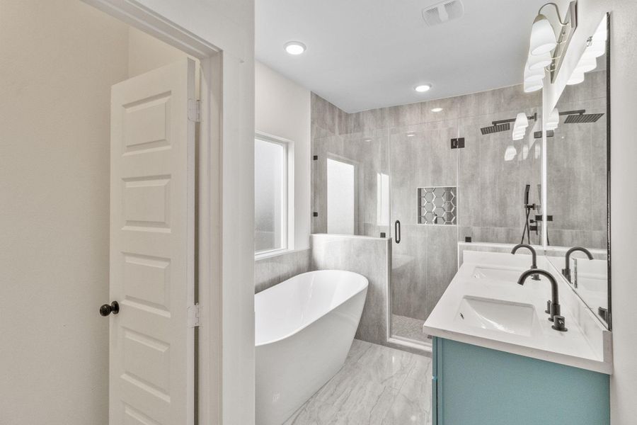 Dreamy primary bathroom with a walk in tiled shower and soaking tub! Dreamy primary bathroom with a walk in tiled shower and soaking tub!