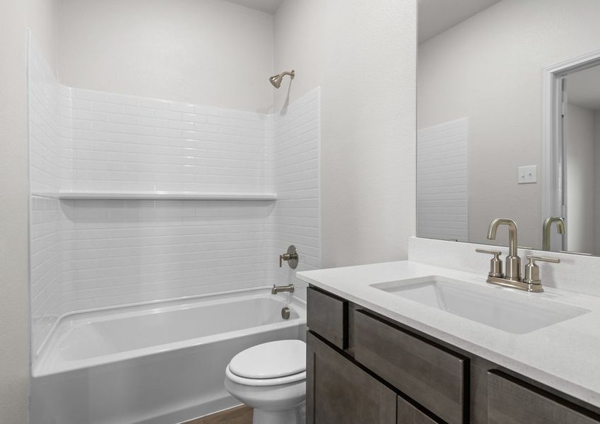 The master bathroom has a sprawling vanity and shower-tub combo.