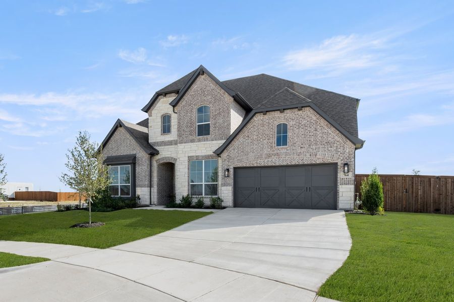 Front exterior of a new home in Myrtle Creek, Waxahachie, TX, highlighting curb appeal (Image 21). Front exterior of a new home in Myrtle Creek, Waxahachie, TX, highlighting curb appeal (Image 21).