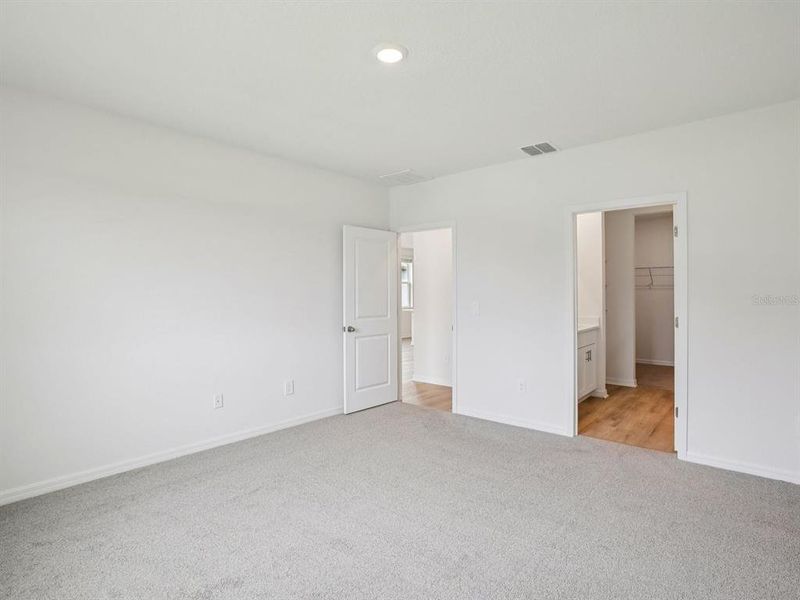 Spacious, unfurnished interior of a new home in The Grove at Stuart Crossing - Premier Series, Bartow (Image 21).
