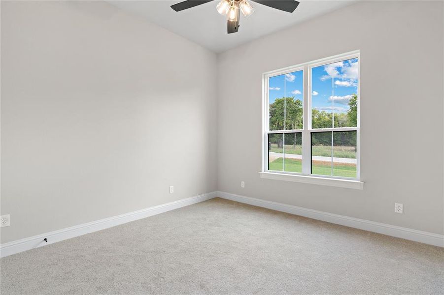 Spare room featuring ceiling fan and carpet floors