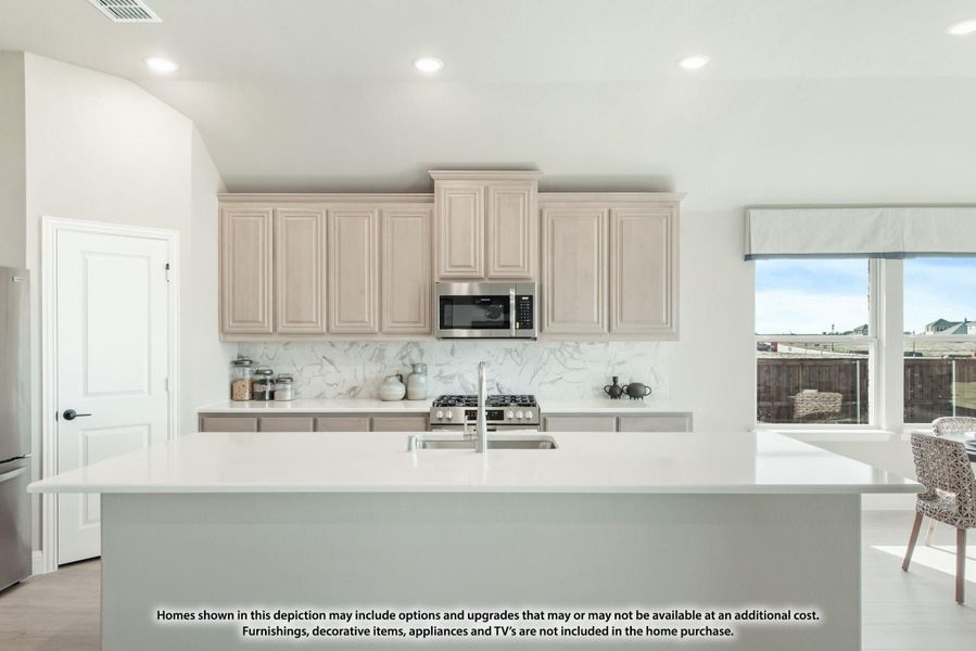 Kitchen with large white island, light wood cabinets, marble backsplash, and stainless steel appliances Kitchen with large white island, light wood cabinets, marble backsplash, and stainless steel appliances