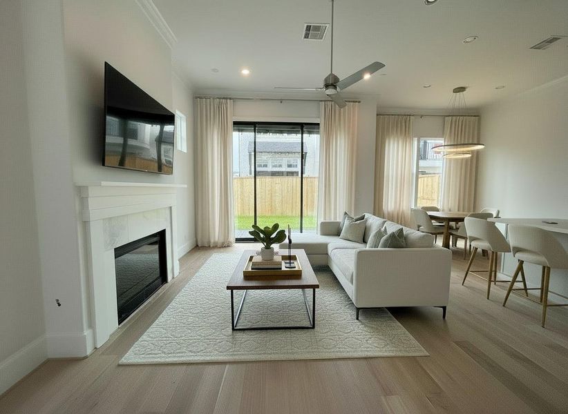 soaring 12ft ceilngs and epic 10ft glass sliding door and gaslog fireplace (furniture rendering for design inspiration but this is an actual photo of the home