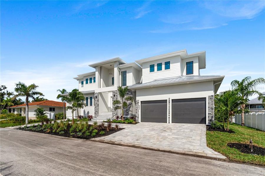 Front exterior of a new home in , Longboat Key, FL, highlighting curb appeal (Image 2). Front exterior of a new home in , Longboat Key, FL, highlighting curb appeal (Image 2).