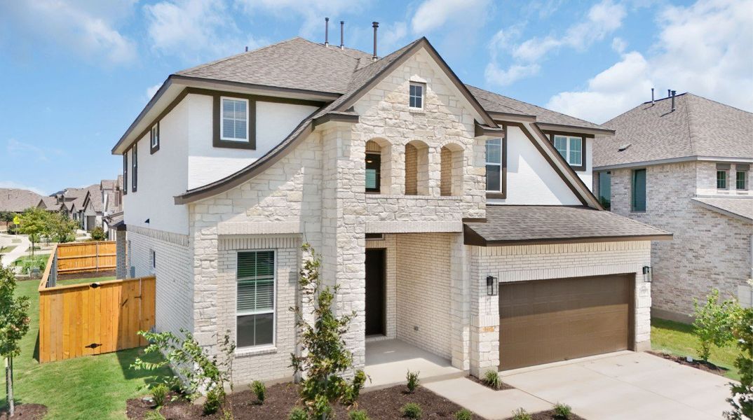 Front exterior of a new home in Lariat, Liberty Hill, TX, highlighting curb appeal (Image 26). Front exterior of a new home in Lariat, Liberty Hill, TX, highlighting curb appeal (Image 26).