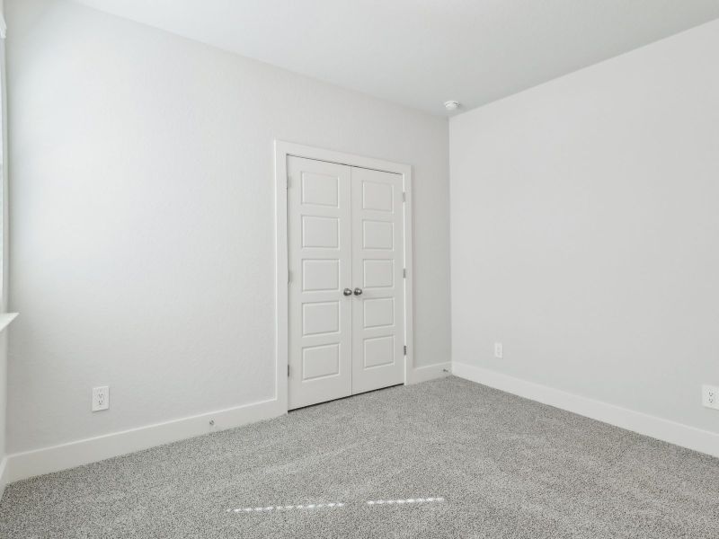 Guest bedroom in the San Saba floorplan at a Meritage Homes community.