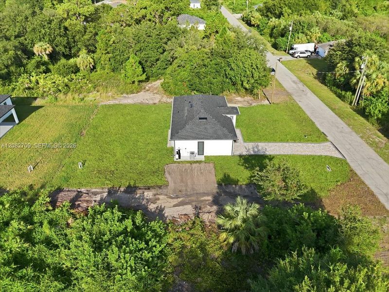 Front exterior of a new home in , Lehigh Acres, FL, highlighting curb appeal (Image 25).