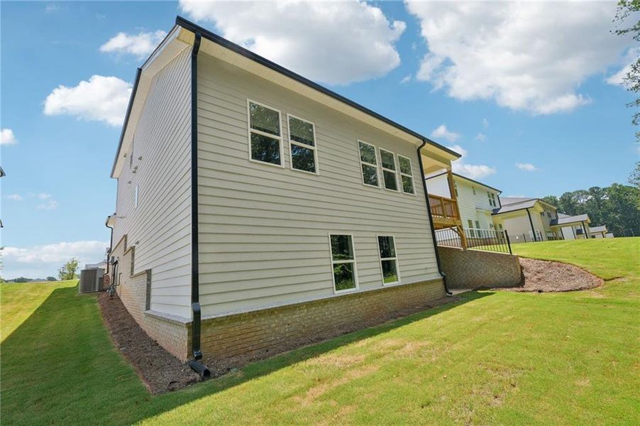 Front exterior of a new home in Martin Springs - Estate Series, Lawrenceville, GA, highlighting curb appeal (Image 24). Front exterior of a new home in Martin Springs - Estate Series, Lawrenceville, GA, highlighting curb appeal (Image 24).