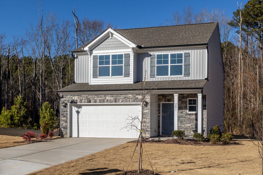 Front exterior of a new home in Daniel Farms, Benson, NC, highlighting curb appeal (Image 2). Front exterior of a new home in Daniel Farms, Benson, NC, highlighting curb appeal (Image 2).
