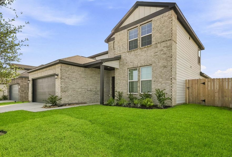 Front exterior of a new home in Mirabella, Brookshire, TX, highlighting curb appeal (Image 2). Front exterior of a new home in Mirabella, Brookshire, TX, highlighting curb appeal (Image 2).