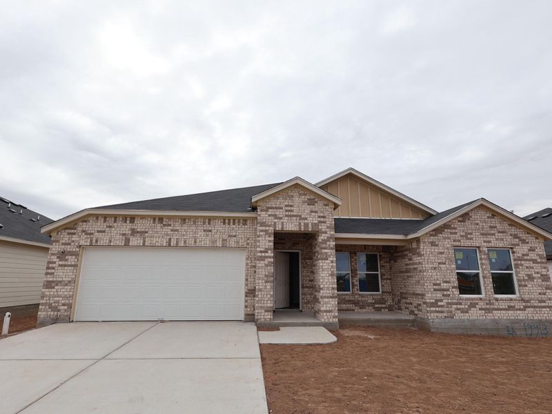 Front exterior of a new home in Carillon, Manor, TX, highlighting curb appeal (Image 2).