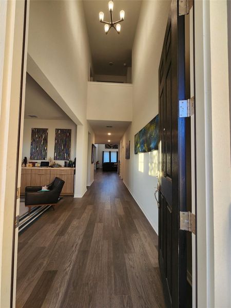 A welcoming entryway with soaring ceilings guides the eye through to the home's inviting interior.