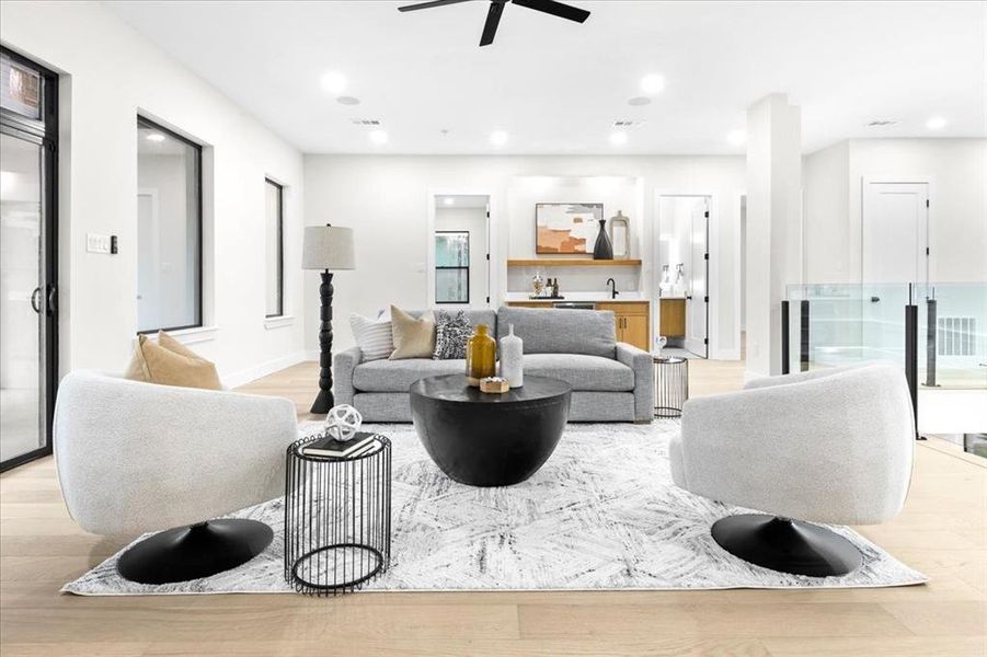 Living room featuring ceiling fan and light wood-type flooring