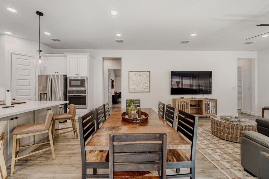 Dining space with recessed lighting and light wood-style floors