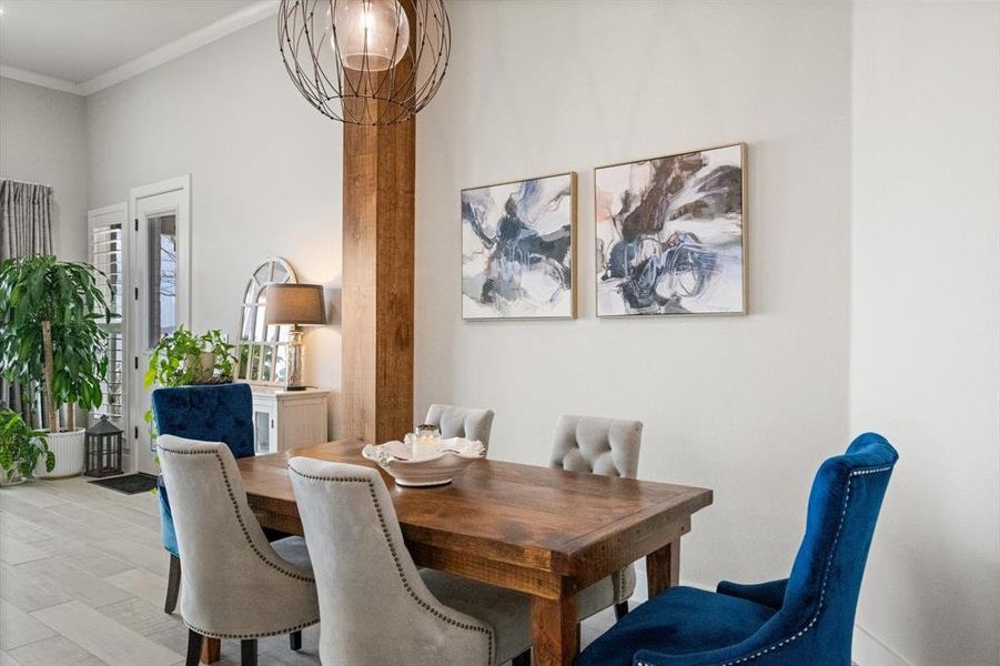 Dining area with crown molding and wood-look tile floors