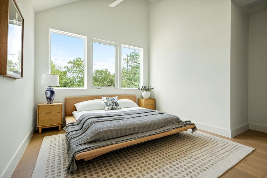 Tall windows and soaring vaulted ceilings define this peaceful sleeping chamber.