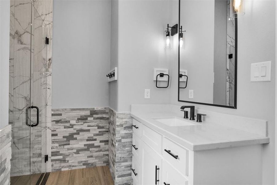 Simplistic modern fixtures and mirrors keep the bath design clean and fresh.