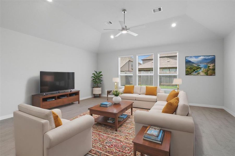 Gather the family and guests together in your lovely living room! Featuring high ceilings, recessed lighting, ceiling fan, custom paint, gorgeous floors and large windows that provide plenty of natural lighting throughout the day.