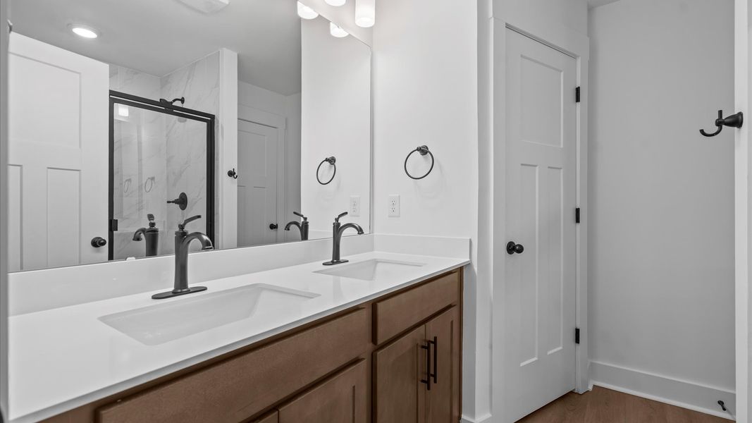 Superior en-suite primary bathroom with stylish dual vanity and tiled walk-in shower crafted with high standards in mind Superior en-suite primary bathroom with stylish dual vanity and tiled walk-in shower crafted with high standards in mind