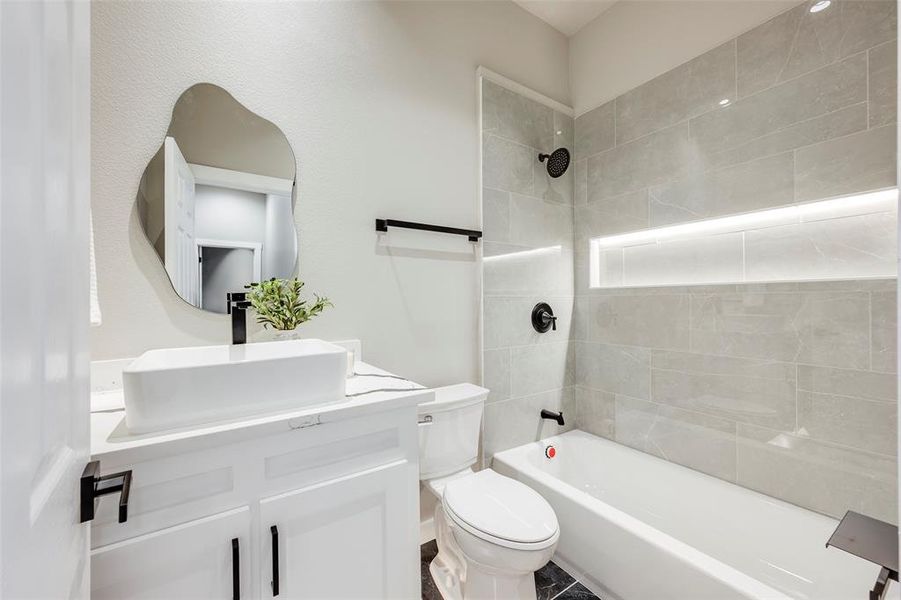 Bathroom with shower / bath combination and vanity