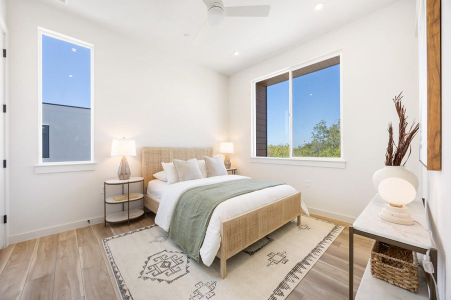 Bedroom with light wood-style floors, a ceiling fan, and recessed lighting. Bedroom with light wood-style floors, a ceiling fan, and recessed lighting.