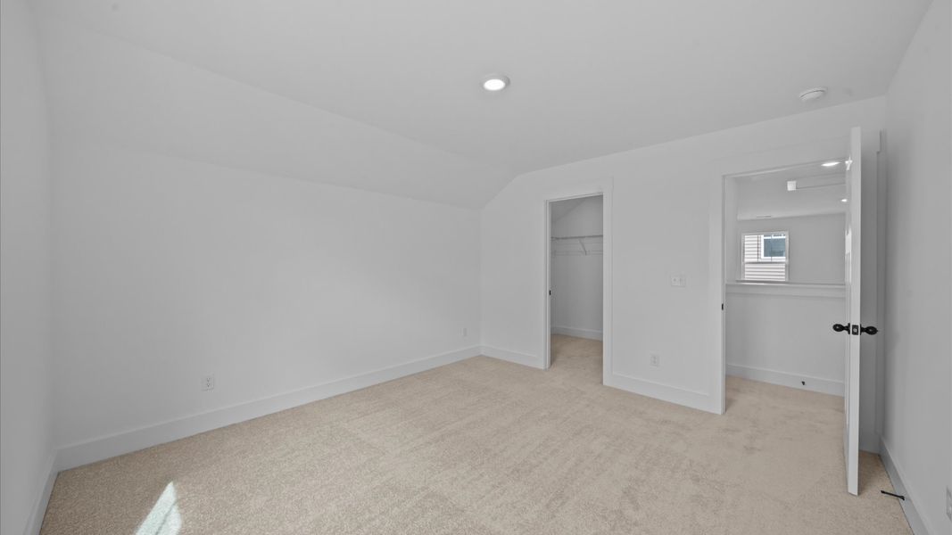 Accomplished design shines in this carpeted bedroom with a functional walk-in closet Accomplished design shines in this carpeted bedroom with a functional walk-in closet