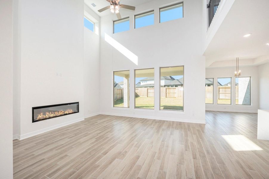 The living area features an electric fireplace with a sleek, modern design, creating a warm and inviting ambiance. Its elegant detailing and soft glow serve as a stunning focal point, perfectly complementing the home’s sophisticated style while offering effortless comfort at the touch of a button.