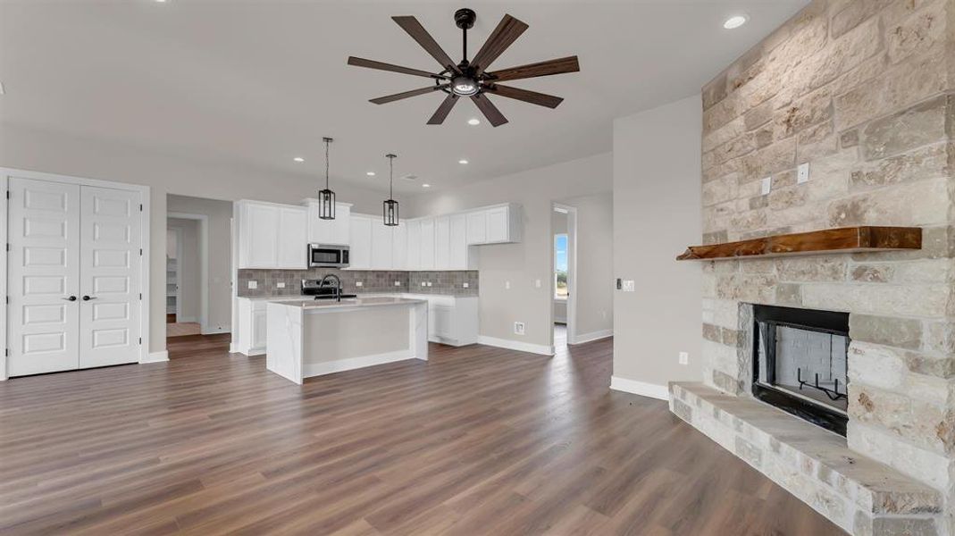 Rich wood floors anchor an open interior complete with a classic stone fireplace. Rich wood floors anchor an open interior complete with a classic stone fireplace.