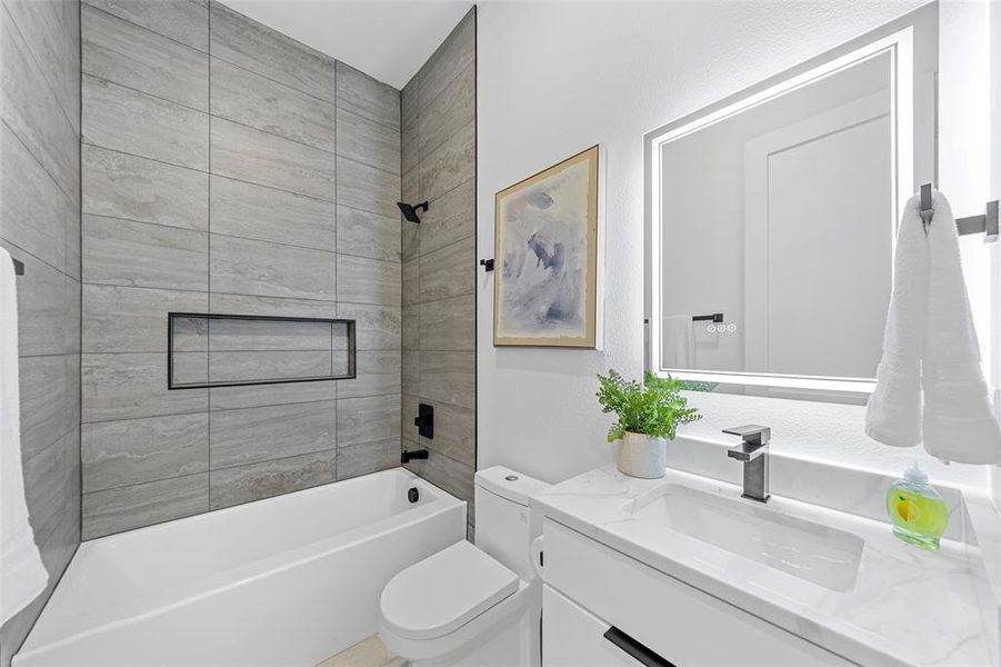 Bathroom featuring bathtub / shower combination and vanity Bathroom featuring bathtub / shower combination and vanity