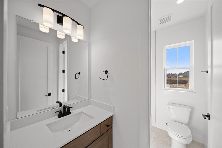 Bathroom featuring vanity and light tile patterned floors