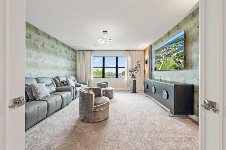 Large 16' x 18' home theater with designer wallpaper and curtains.