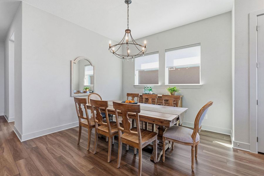 Dining area featuring wood finished floors and a chandelier Dining area featuring wood finished floors and a chandelier